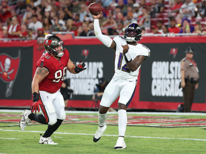 Baltimore Ravens quarterback Anthony Brown (12) throws the ball as Tampa Bay Buccaneers defensive tackle Greg Gaines (96) defends during the second quarter at Raymond James Stadium. Mandatory Credit: Kim Klement Neitzel-USA TODAY Sports